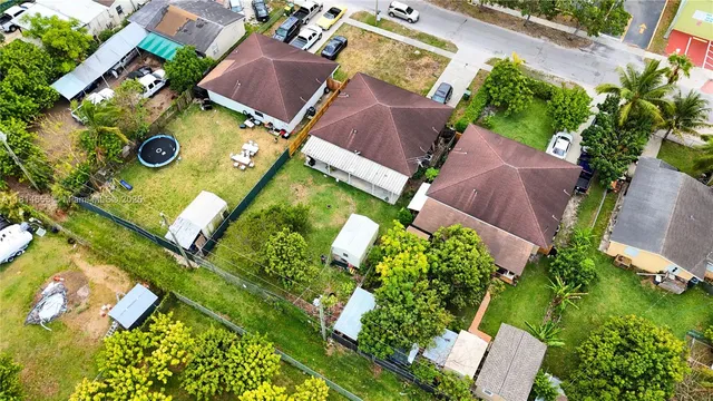 an aerial view of a house with garden space and street view