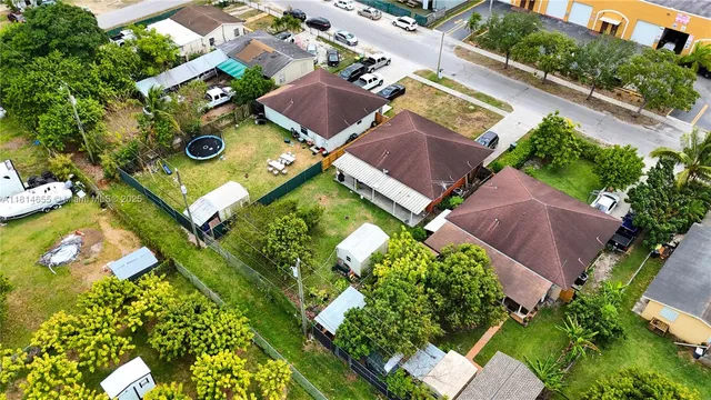 an aerial view of residential house with outdoor space and a street view
