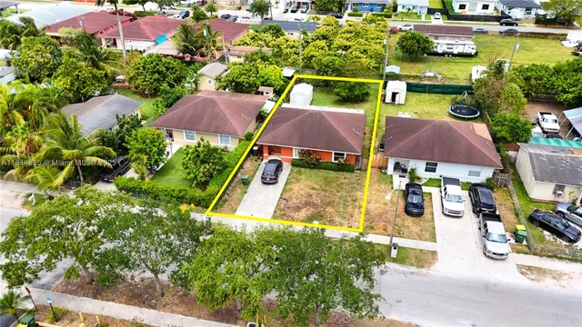 an aerial view of multiple houses with yard