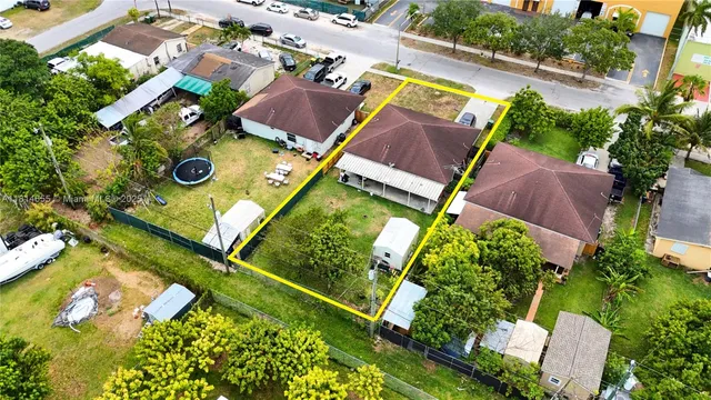 an aerial view of a house with a yard and garden