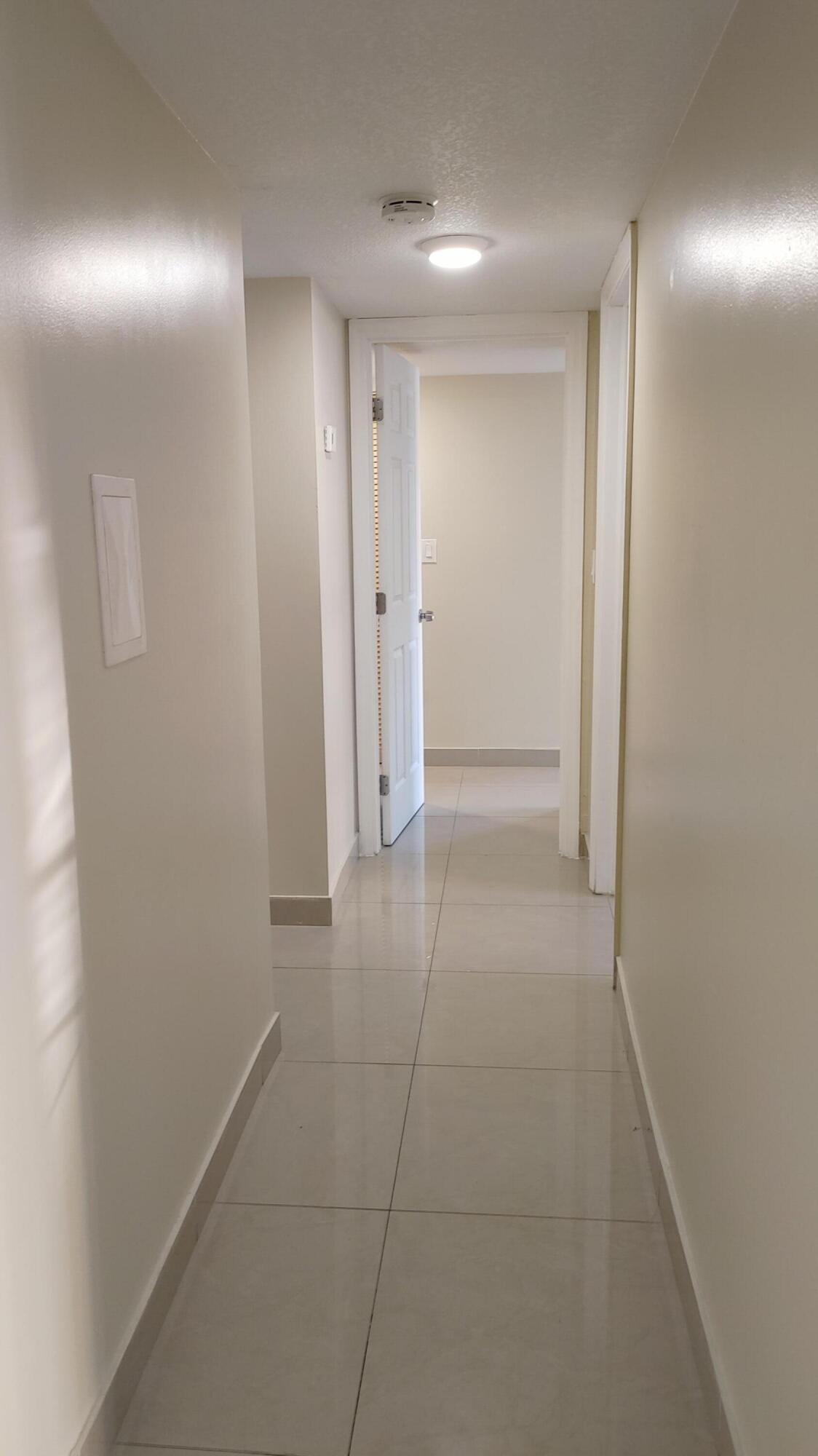 3710 Northwest 21st Street, Unit 106 Lauderdale Lakes, FL 33311 - Photo 4 of 4 a view of hallway with an empty space