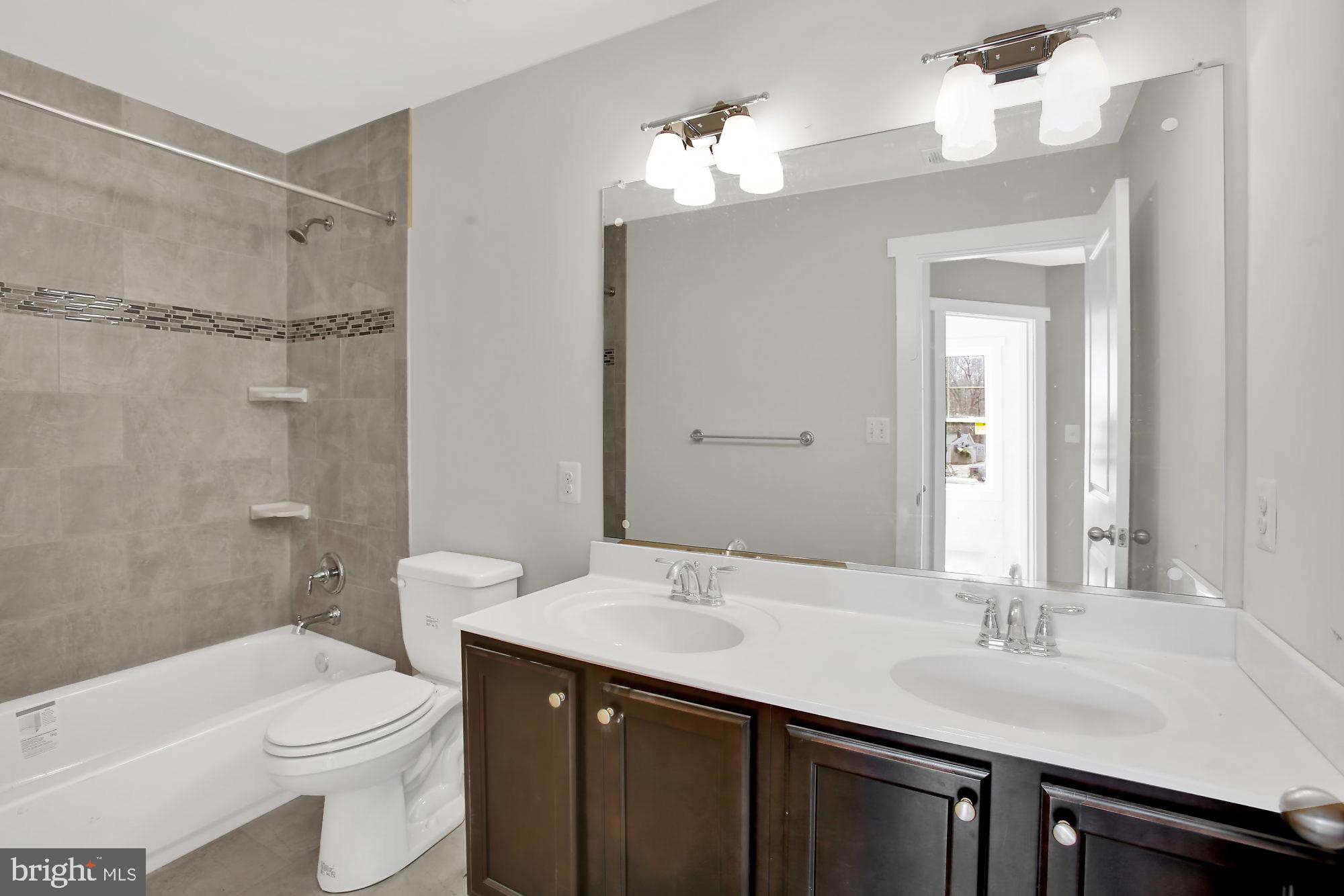 608 Powhatan Beach Road Pasadena, MD 21122 - Photo 13 of 28 Hall bath with double vanity