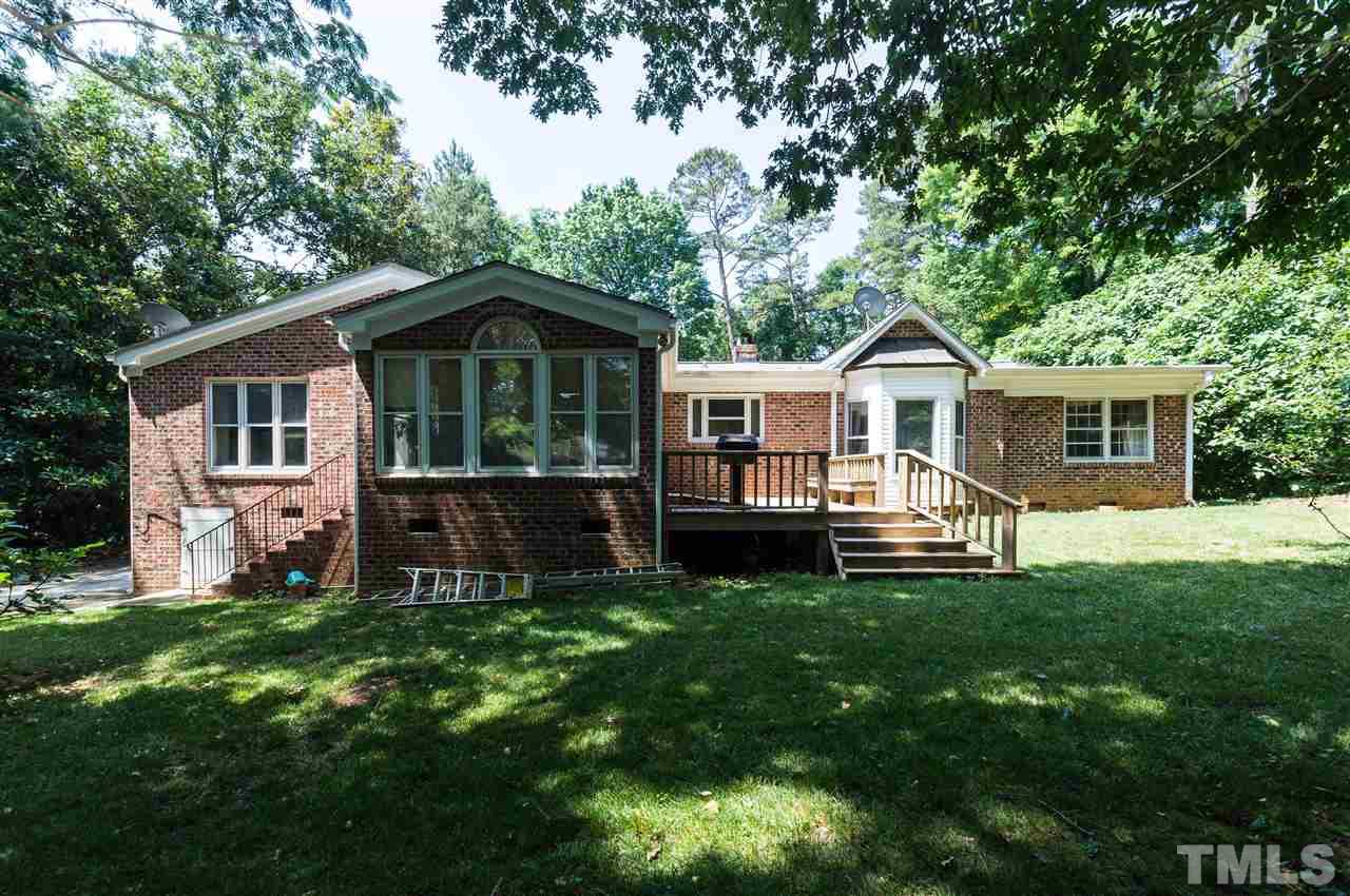 1926 Highland Place Raleigh, NC 27607 - Photo 22 of 23 a front view of a house with a yard porch and wooden fence