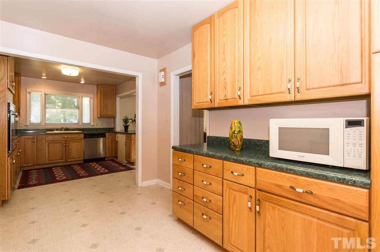 1926 Highland Place Raleigh, NC 27607 - Photo 7 of 23 a kitchen with granite countertop a sink and cabinets