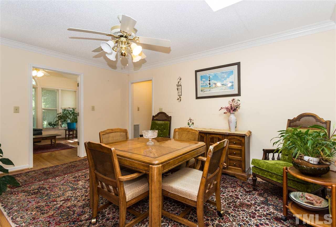 1926 Highland Place Raleigh, NC 27607 - Photo 9 of 23 a view of a dining room with furniture and a chandelier