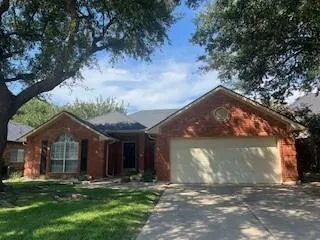 a front view of a house with a garden and yard