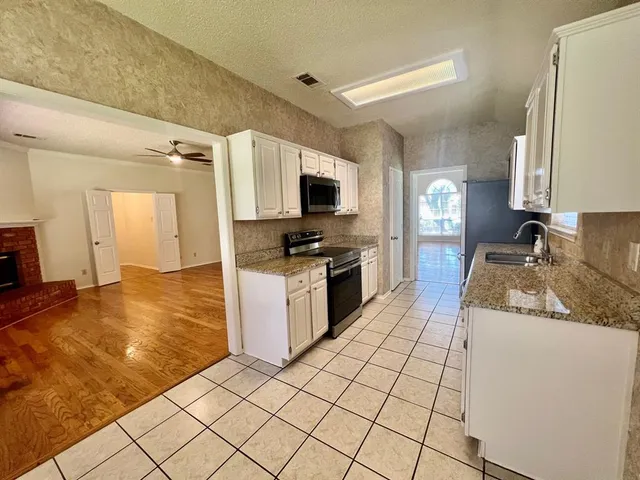 a kitchen with a stove a sink and a refrigerator
