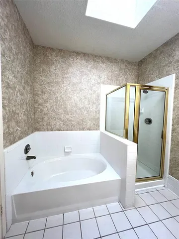 a bathroom with a bathtub and shower