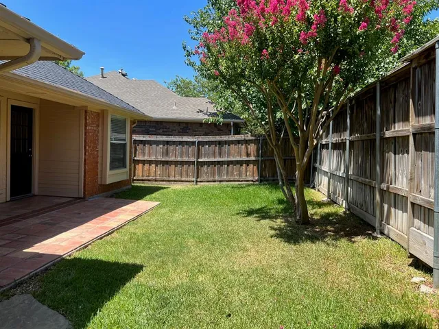 a view of an house with backyard space and balcony