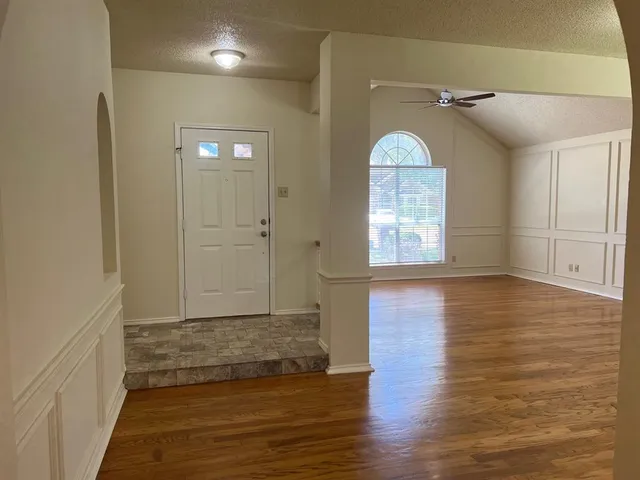 wooden floor in an empty room with a window