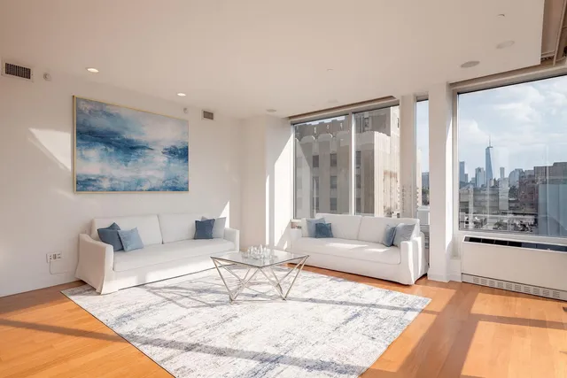 a large bed sitting in a bedroom next to a window