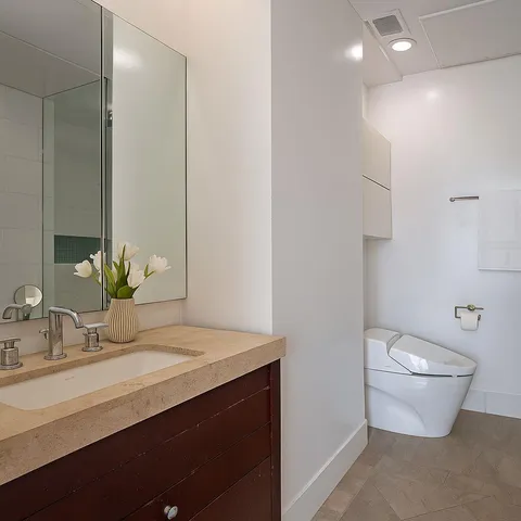 a bathroom with a sink a faucet and a light fixture