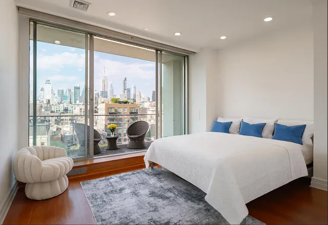 a bedroom with a bed and a chandelier