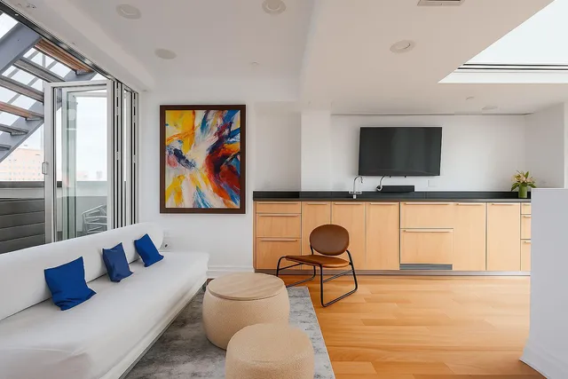 a living room with a large window and a table