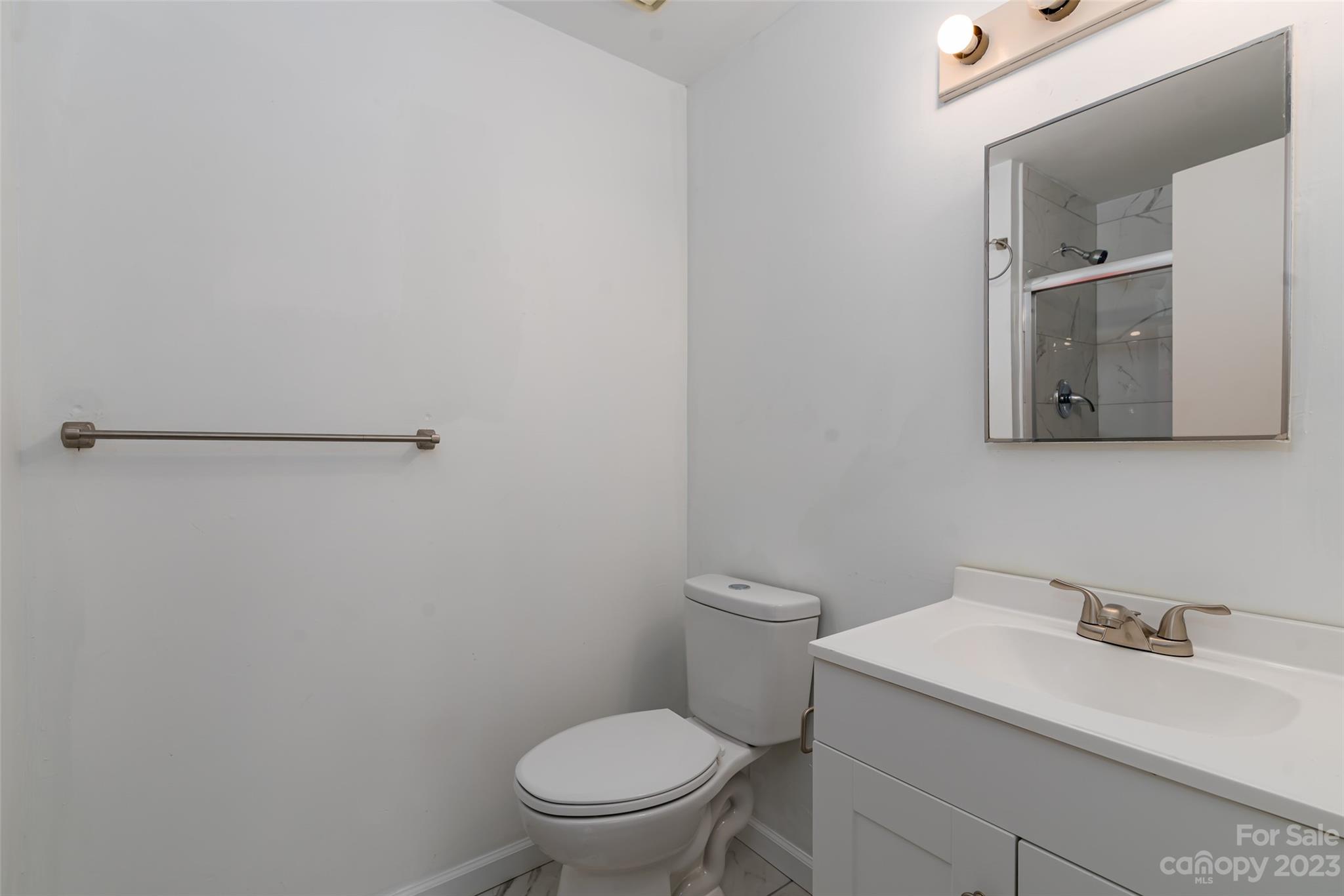 9333 Old Concord Road, Unit J Charlotte, NC 28213 - Photo 12 of 17 a white toilet sitting next to a bathroom sink