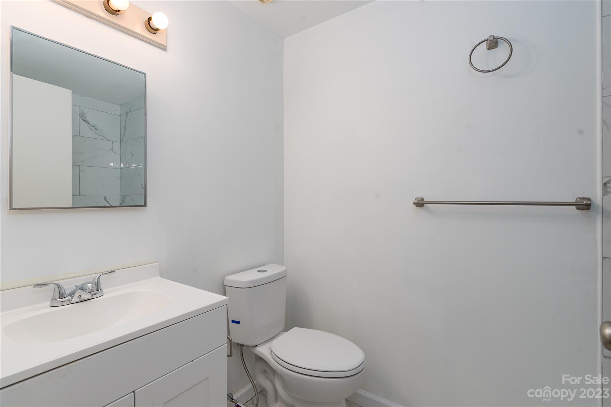9333 Old Concord Road, Unit J Charlotte, NC 28213 - Photo 15 of 17 a white toilet sitting next to a bathroom sink