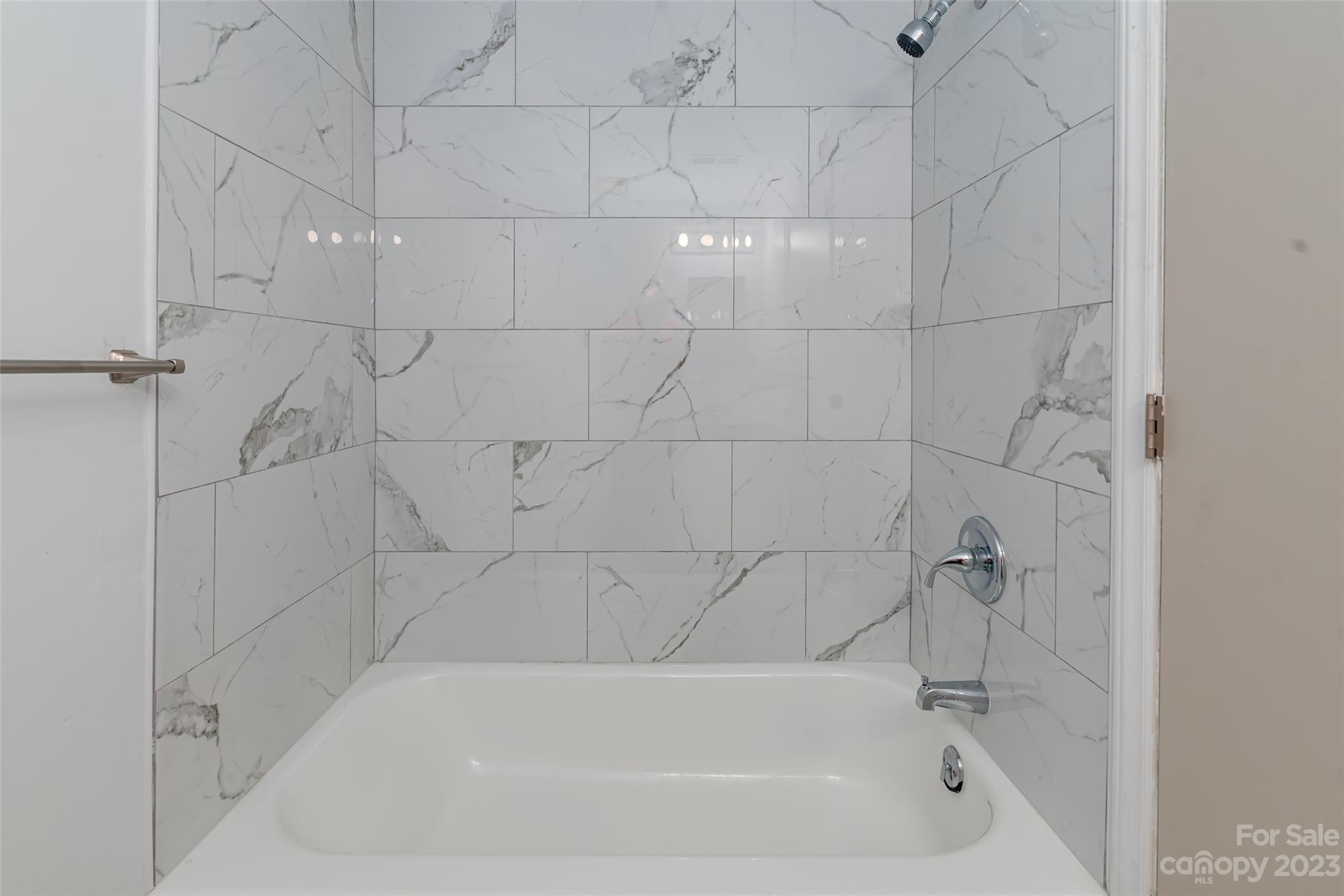 9333 Old Concord Road, Unit J Charlotte, NC 28213 - Photo 16 of 17 a white bath tub sitting in a bathroom