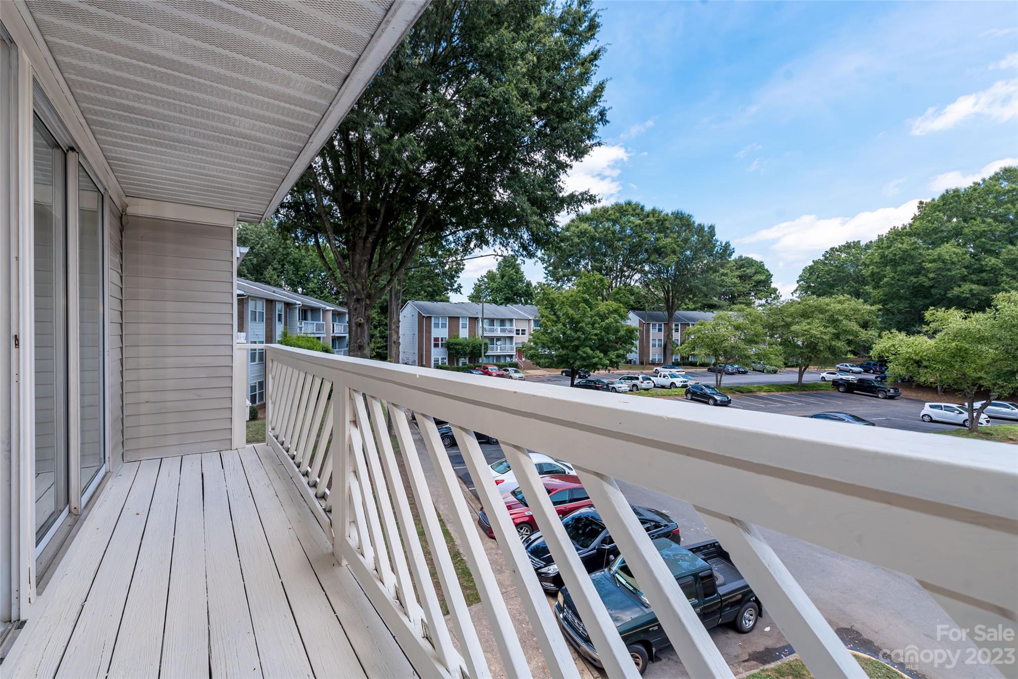 9333 Old Concord Road, Unit J Charlotte, NC 28213 - Photo 4 of 17 a view of a balcony with wooden floor and fence