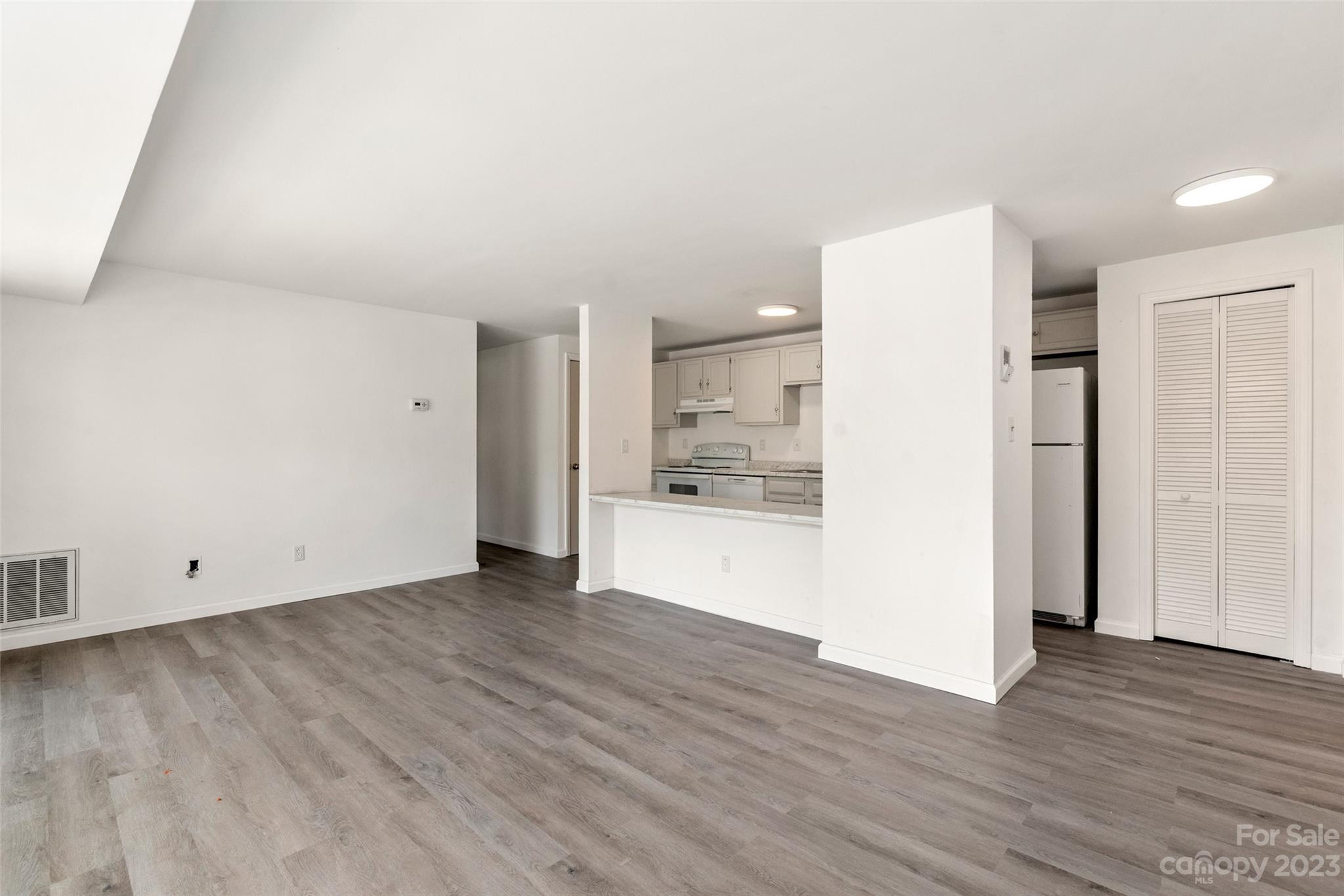 9333 Old Concord Road, Unit J Charlotte, NC 28213 - Photo 5 of 17 a view of an empty room with wooden floor and a window
