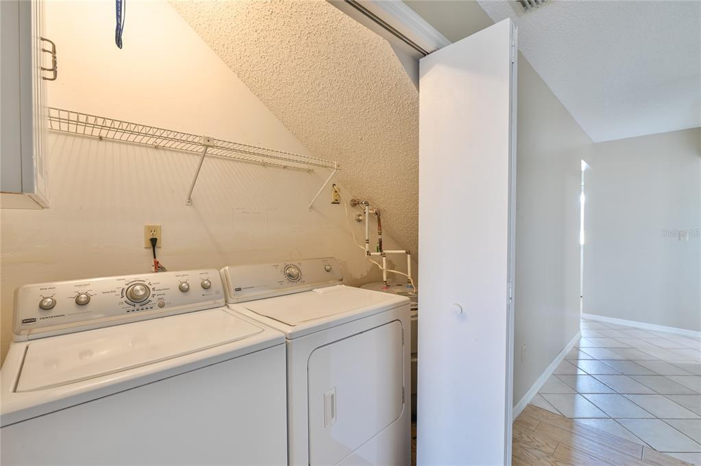11001 Southeast Sunset Harbor Road, Unit H52 Summerfield, FL 34491 - Photo 19 of 31 a utility room with dryer and washer