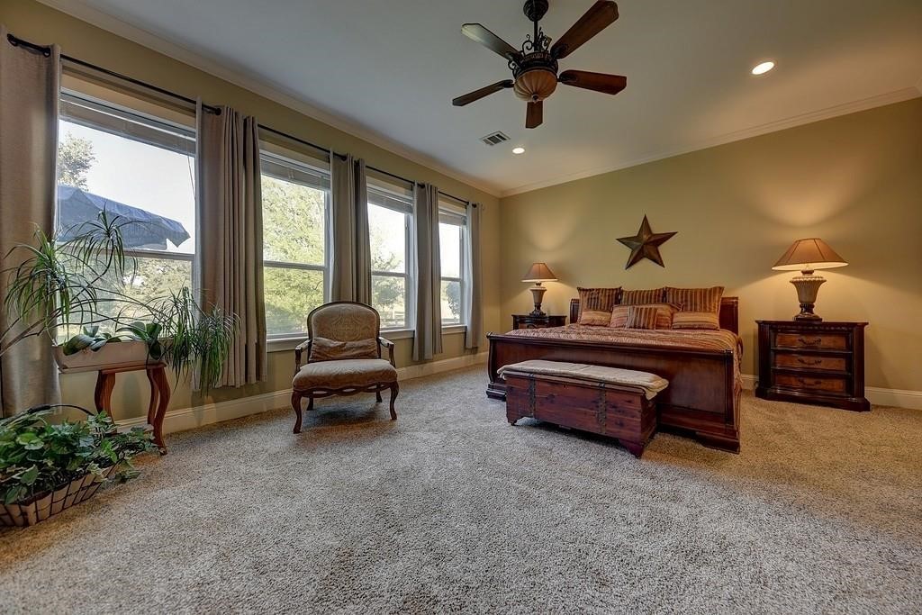 8456 Schuster Road Ledbetter, TX 78946 - Photo 21 of 49 a bedroom with a bed and a chandelier