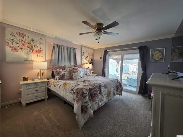 a spacious bedroom with a bed and a window