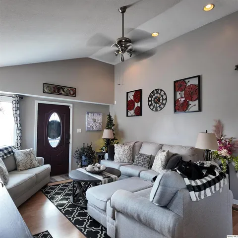 a living room with furniture and a chandelier