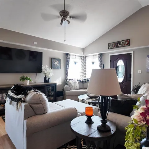 a living room with furniture and a wooden floor