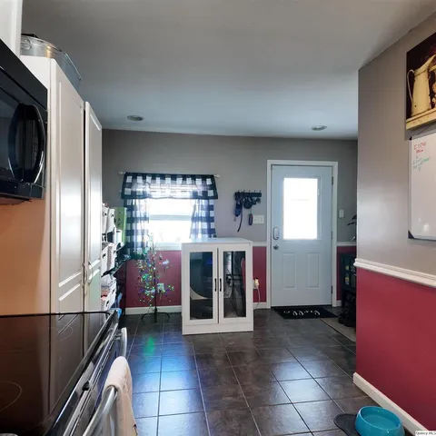 a kitchen with a refrigerator and window
