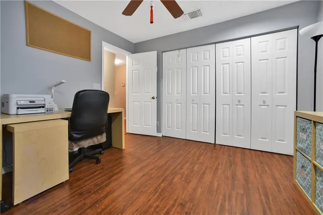 a view of workspace with wooden floor and furniture