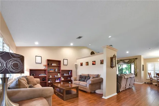 a living room with furniture and a wooden floor