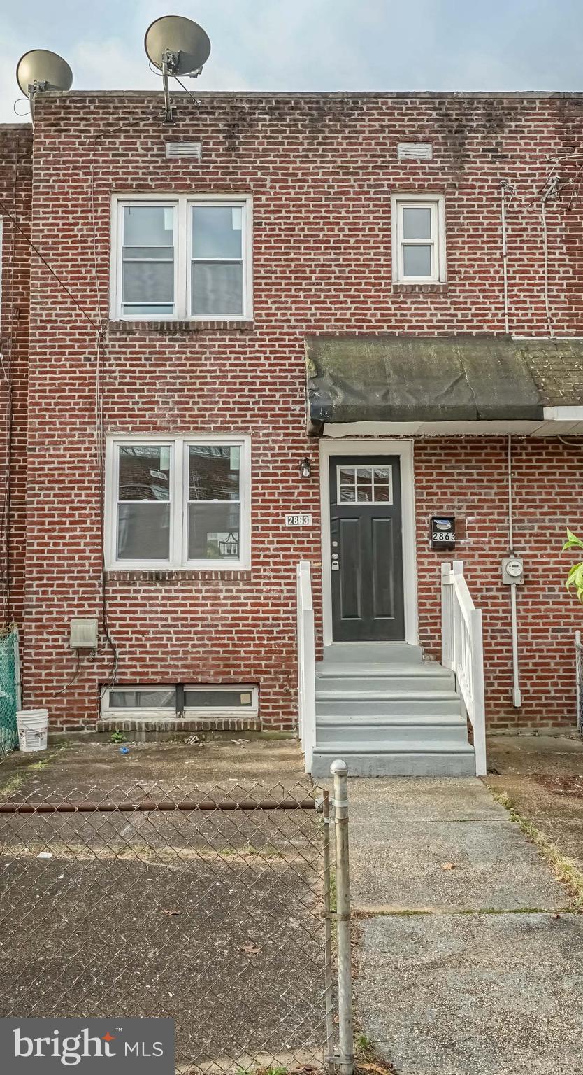 2863 Cushing Road Camden, NJ 08104 - Photo 1 of 33 a front view of a house with a yard and garage