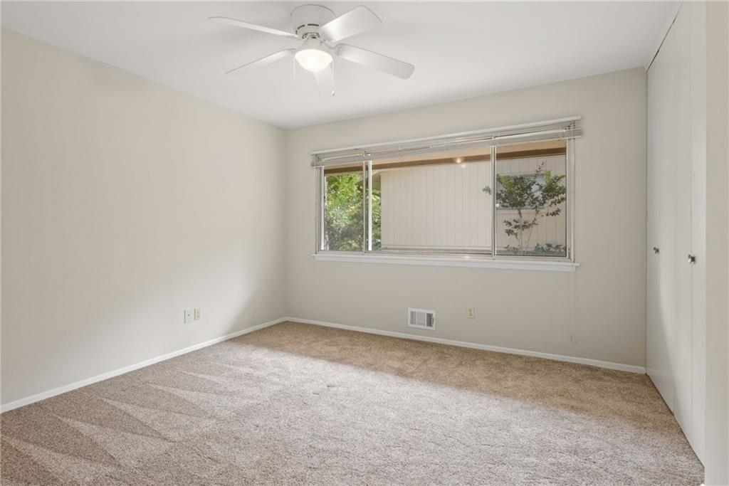 705 Edgewater Trail Sandy Springs, GA 30328 - Photo 25 of 36 an empty room with a window and a ceiling fan