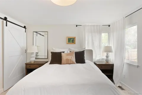 a bedroom with a large bed and a window
