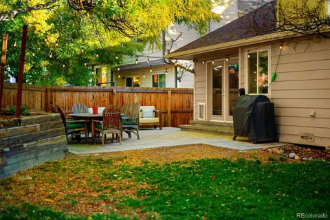 a view of backyard of house with seating area