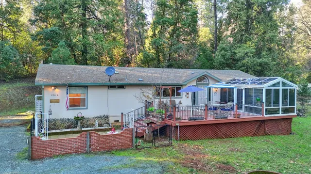 an aerial view of a house with a yard balcony and furniture