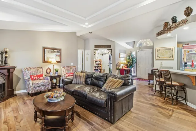 a kitchen with a stove a sink dishwasher and a refrigerator with wooden floor