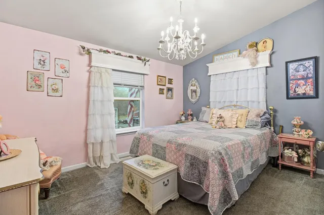 a backyard of a house with barbeque oven table and chairs