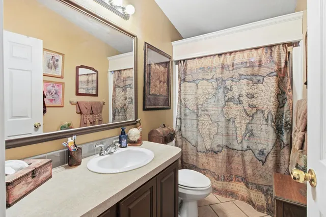 front view of a house with a large tree