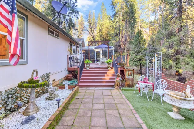 a view of a porch with furniture and trees