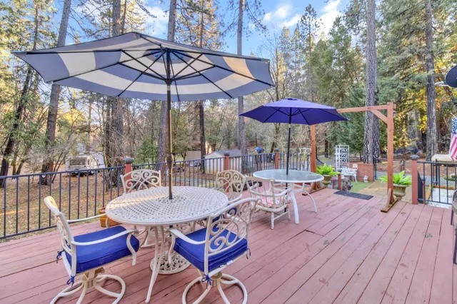 a table and chairs in the patio and a umbrella