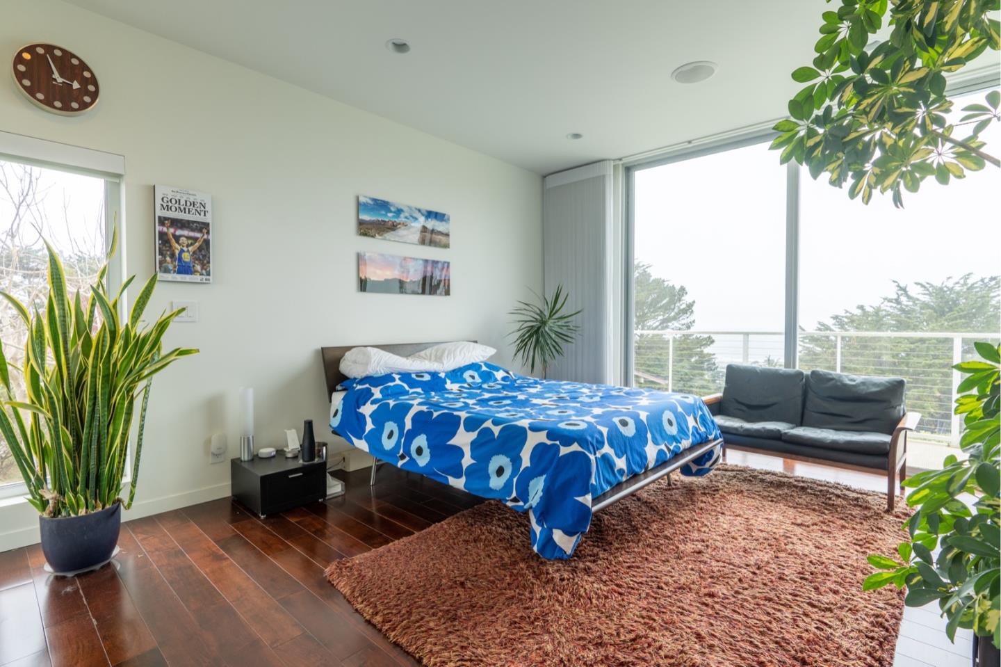 451 Talbot Avenue Pacifica, CA 94044 - Photo 16 of 38 a bedroom with a bed a table and a potted plant