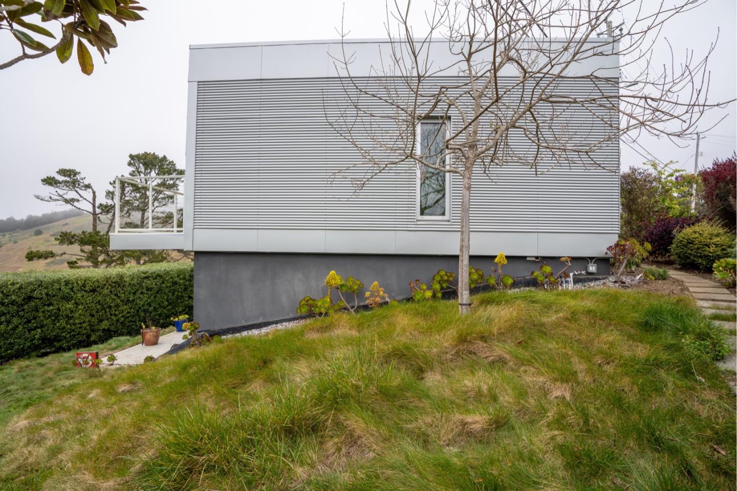 451 Talbot Avenue Pacifica, CA 94044 - Photo 25 of 38 a backyard of a house with plants and large tree