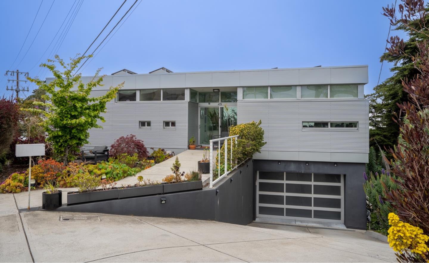 451 Talbot Avenue Pacifica, CA 94044 - Photo 3 of 38 a front view of a house with a yard and garage