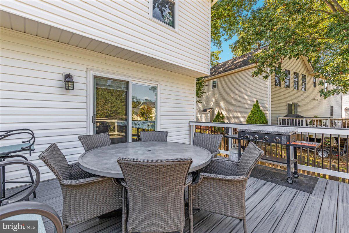 129 Old Wagon Road Winchester, VA 22602 - Photo 30 of 59 a view of a patio with table and chairs with wooden floor and fence