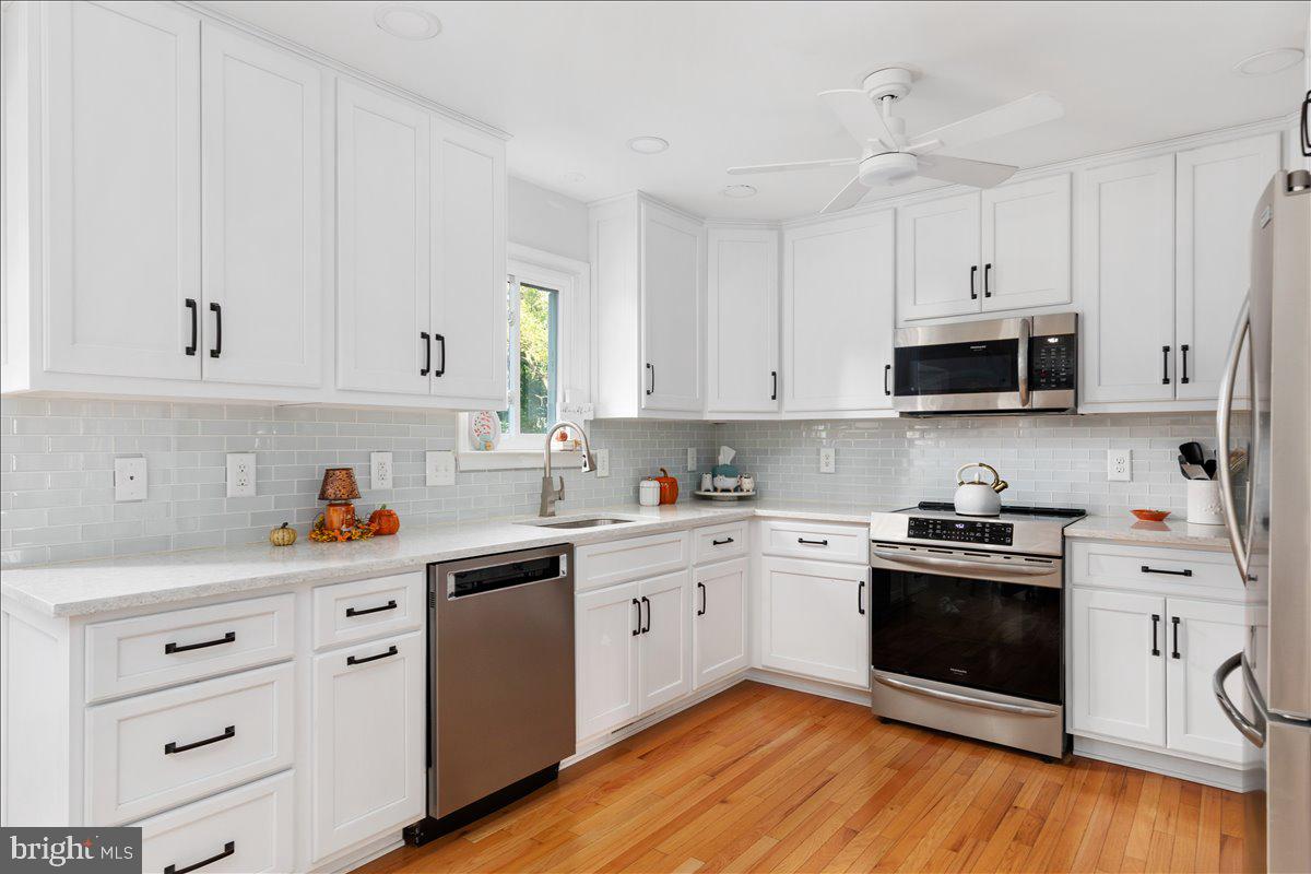 129 Old Wagon Road Winchester, VA 22602 - Photo 3 of 59 a kitchen with cabinets stainless steel appliances a sink and wooden floor
