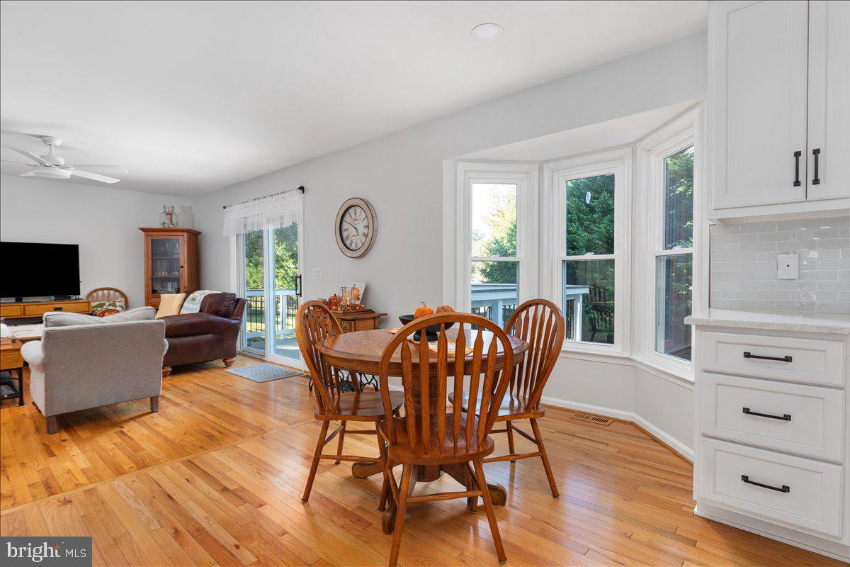 129 Old Wagon Road Winchester, VA 22602 - Photo 5 of 59 a view of a dining room with furniture window and wooden floor