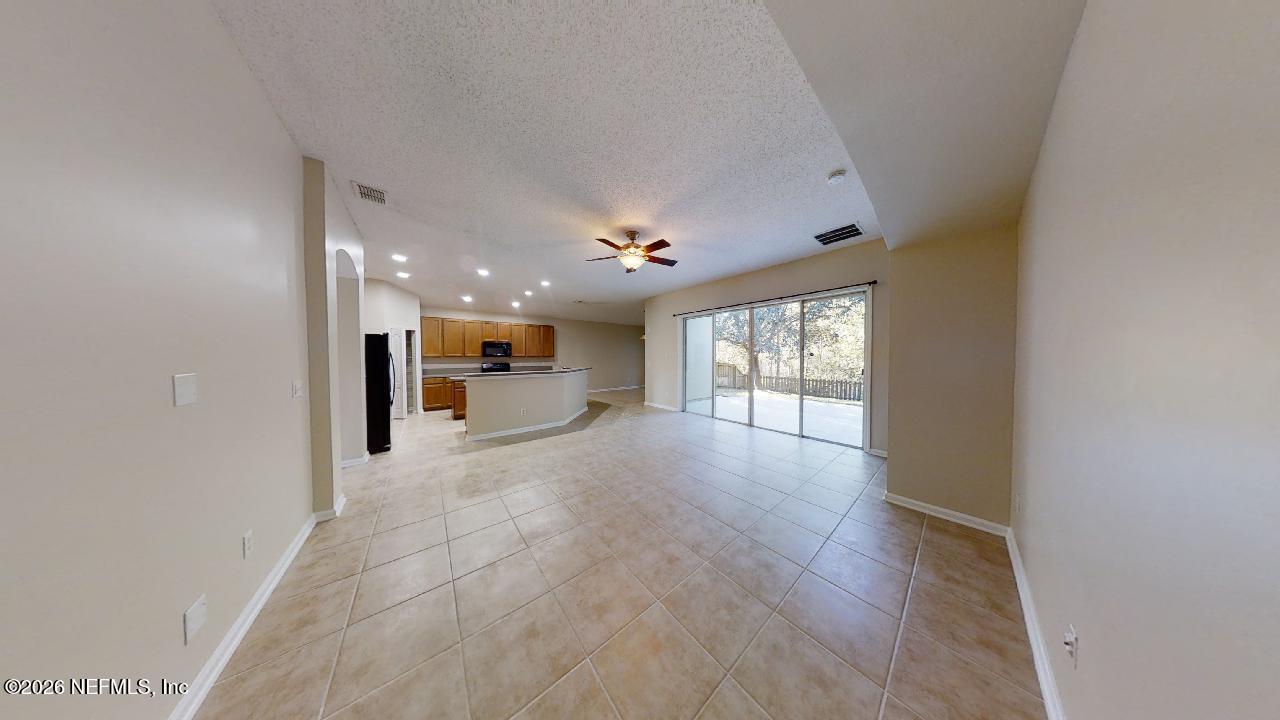 14454 Millhopper Road Jacksonville, FL 32258 - Photo 12 of 44 a view of an empty room with a window