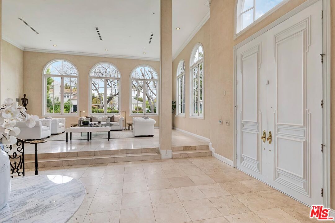 110 North Oakhurst Drive Beverly Hills, CA 90210 - Photo 2 of 29 a living room with furniture and a large window