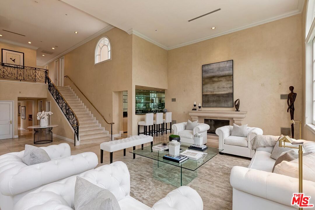 110 North Oakhurst Drive Beverly Hills, CA 90210 - Photo 5 of 29 a living room with furniture and a large window